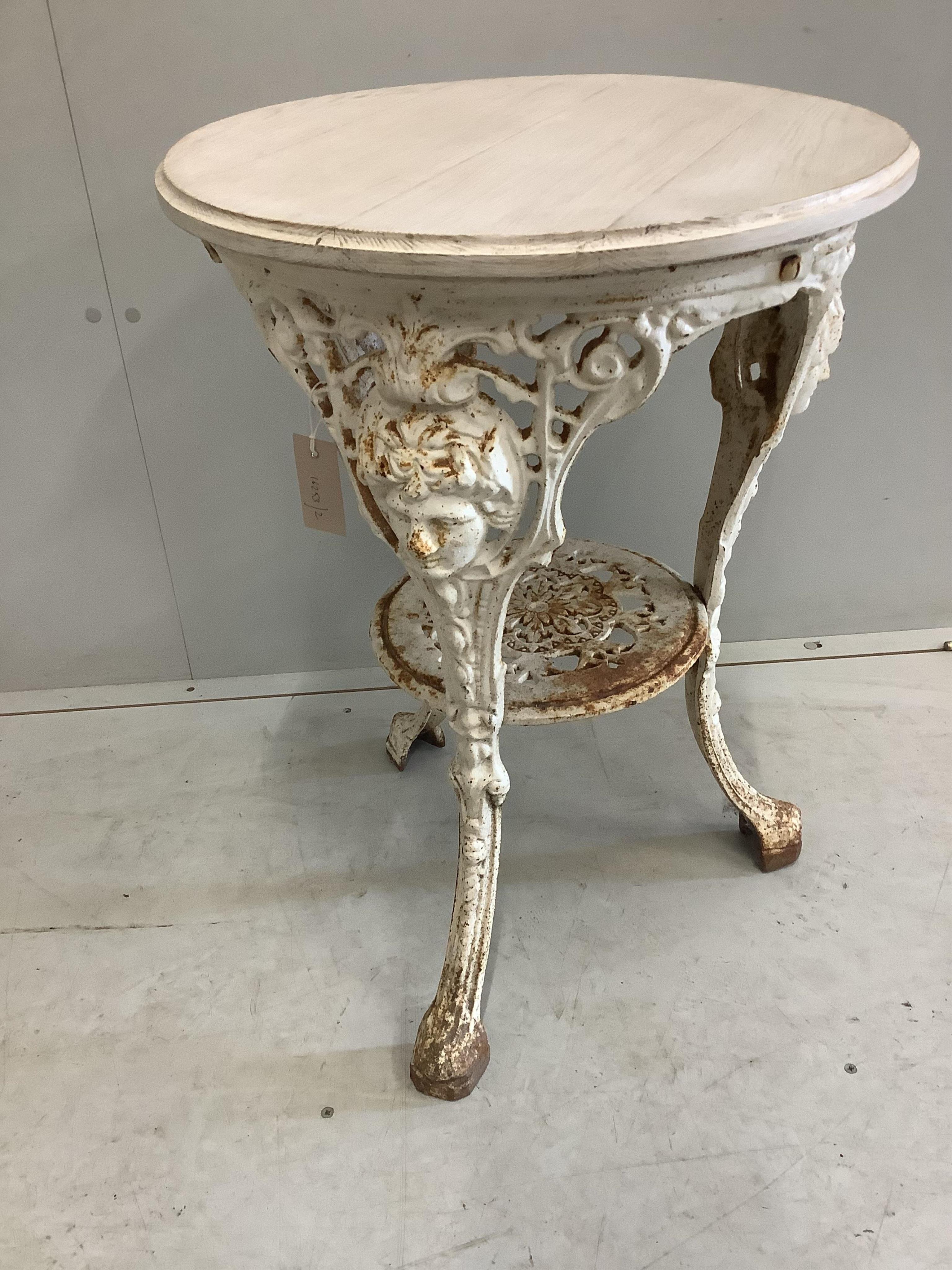 A white painted cast iron circular pub table, with later white stained wooden top, diameter 50cm, height 70cm. Condition - some oxidisation, otherwise good